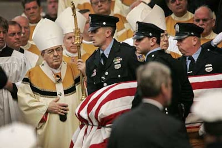 The flag-draped casket of Sgt. Timothy Simpson is carried past Cardinal Justin Rigali after today's Funeral Mass at Cathedral Basilica of Sts. Peter and Paul. (Alejandro A. Alvarez / Staff Photographer)