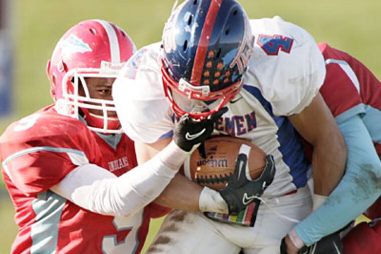 Pennsauken's Ameer Williams, left, tries to bring down Township's John Montesjardi. (Elizabeth Robertson/Staff Photographer)