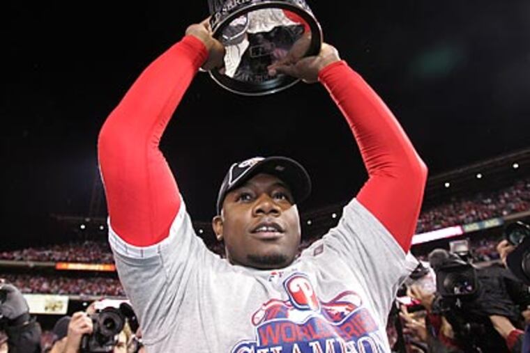 Ryan Howard holds the World Series trophy after the Phillies' triumph last October. (Barbara L. Johnston/Staff file photo)