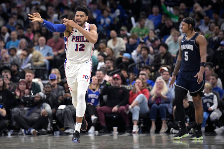 Tobias Harris celebrates his three-pointer as Orlando Magic forward Paolo Banchero reacts during the second half on Dec. 27.