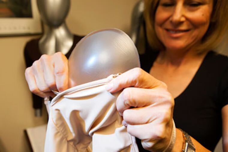 Debra Kimless-Garber inserts a Breast Shaper into one of her mastectomy bras. ED HILLE / Staff Photographer