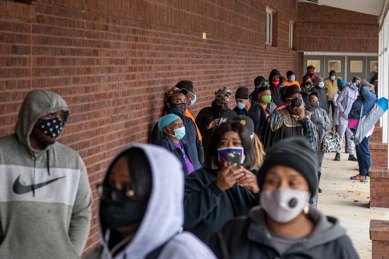 Fulton County, Georgia, residents wait in line to cast their ballots during early voting at the C.T. Martin Natatorium and Recreation Center near the Westhaven neighborhood in Atlanta on Dec. 14, 2020.