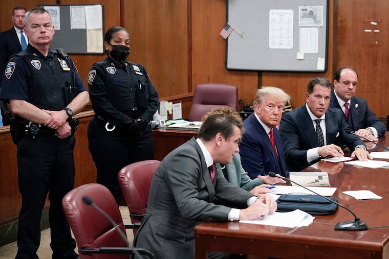 Flanked by attorneys, former U.S. President Donald Trump appears in the courtroom for his arraignment proceeding at Manhattan Criminal Court on Tuesday, April 4, 2023, in New York City. (Seth Wenig/Pool/Getty Images/TNS)