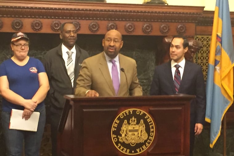 Mayor Nutter (podium) is joined by Julián Castro (right), secretary of the U.S. Department of Housing and Urban Development, and others at Thursday's news conference.