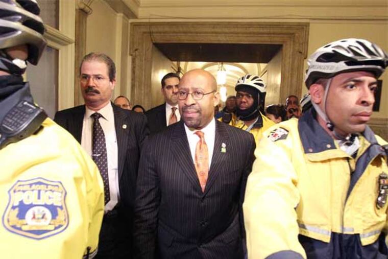 Mayor Nutter is escorted by police after he was unable to to deliver his budget address to City Council. He was unable to do so because of the disruption caused by protesters. (Charles Fox / Staff Photographer)