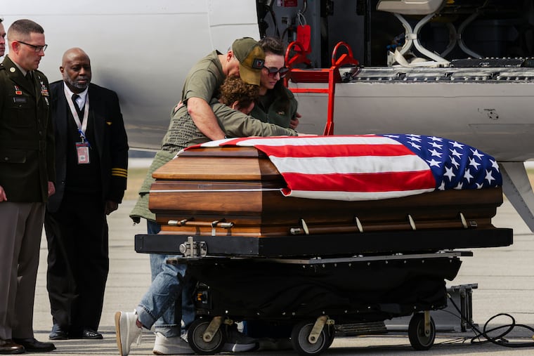 Family members stand with the casket carrying the remains of Army Sgt. Benjamin N. Pennington, 26, of Glendale, Ky., at Godman Army Airfield in Fort Knox, Ky., on Friday, March 20, 2026.