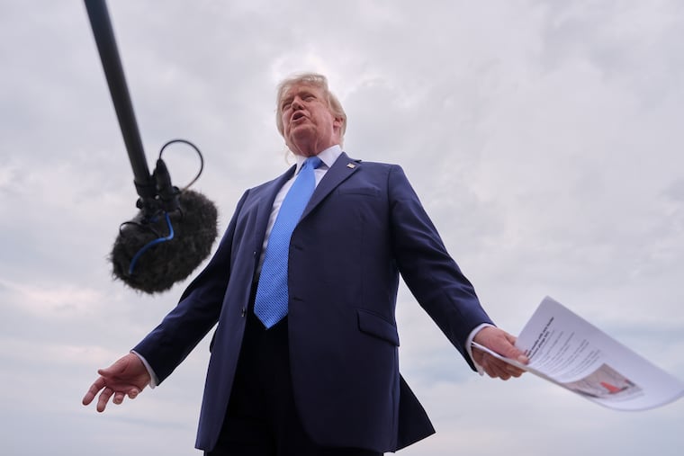 President Donald Trump speaks with reporters before boarding Air Force One, Friday, Aug. 14, 2026, at Joint Base Andrews, Md.