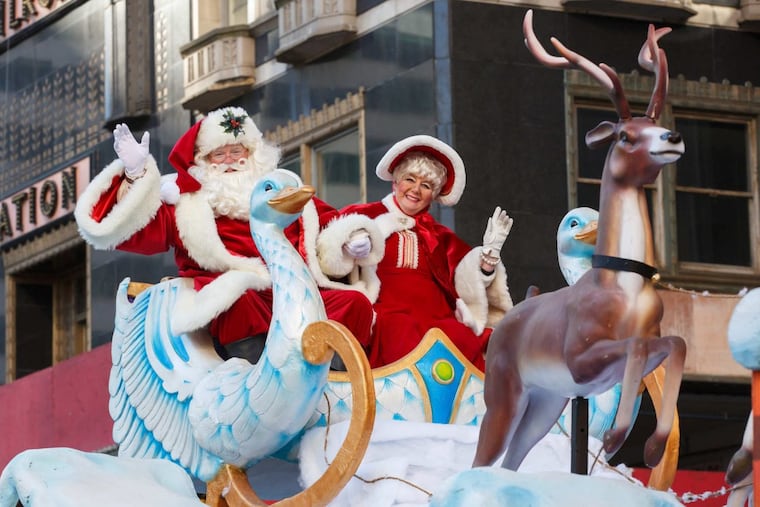Santa Claus and Mrs. Claus greet the crowds from a float on 16th Street at the 98th Annual 6ABC Dunkin’ Donuts Thanksgiving Day Parade, Thursday, Nov. 23, 2017.