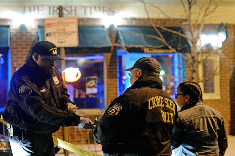 The shooting occurred a block off of South Street, near Headhouse Square. Here, Crime Scene Investigators gather evidence in front of The Irish Times restaurant.
