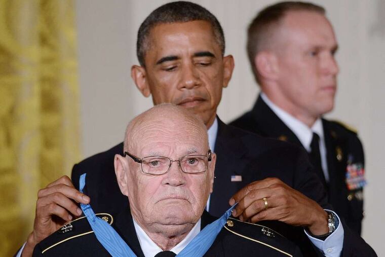 Command Sgt. Maj. Bennie G. Adkins receives the Medal of Honor from President Obama.