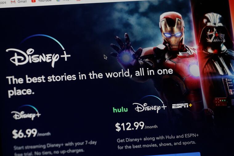 An introductory page on the Disney Plus website is displayed on a computer screen in Walpole, Mass., Wednesday, Nov. 13, 2019. Disney Plus says it hit more than 10 million sign-ups on its first day of launch, far exceeding expectations. (AP Photo/Steven Senne)