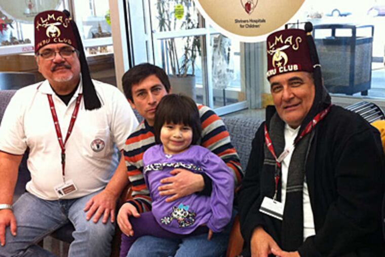 Suhalia Teran Ponce and her father, Florentino Teran Vasquez, came from Peru to Philly for the girl's treatment. (Ronnie Polanecsky/Staff)