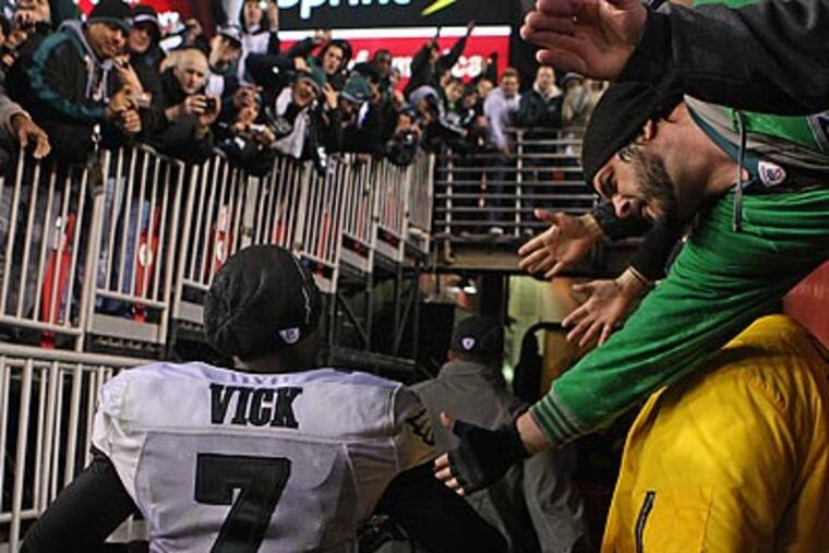 Michael Vick celebrated with fans after leading the Eagles to a record-breaking win over the Redskins. (Ron Cortes/Staff Photographer)