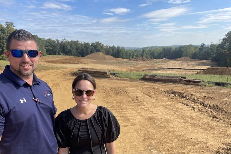 Mike Long and Nicole Fitzgerald of Foxlane Homes, on the hillside site in the Glenmoore section of Wallace Township, Chester County, where their company has begun constructing 36 single-family homes. The Estates at Stonecliff is one of several upscale housing developments proposed or under construction along Devereux Road.