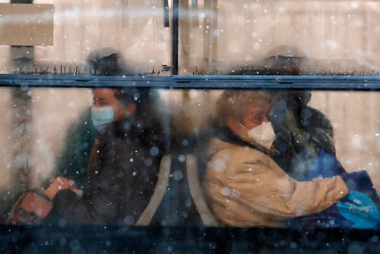 People wearing a face mask to protect against coronavirus sit on a bus in Belgrade, Serbia, Monday, Jan. 11, 2021.