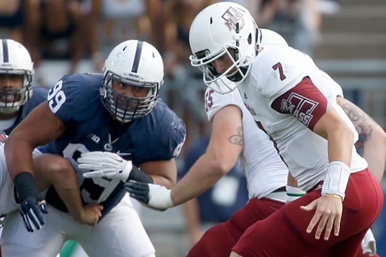 Massachusetts quarterback Blake Frohnapfel (7) fumbles he snap as Penn
State defensive tackle Austin Johnson (99) pressures in the first quarter of an NCAA football game on Saturday, Sept. 20, 2014, in State College, Pa. Penn State won 48-7. (Keith Srakocic/AP)