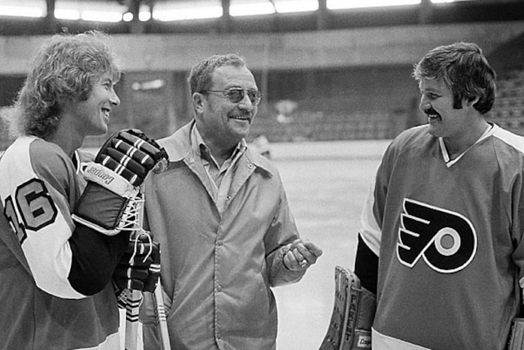 Hockey Hall of Famers Bobby Clarke, left, and Bernie Parent, right, talk with coach Fred Shero, HOF class of 2013. (AP Photo/Bill Ingraham)