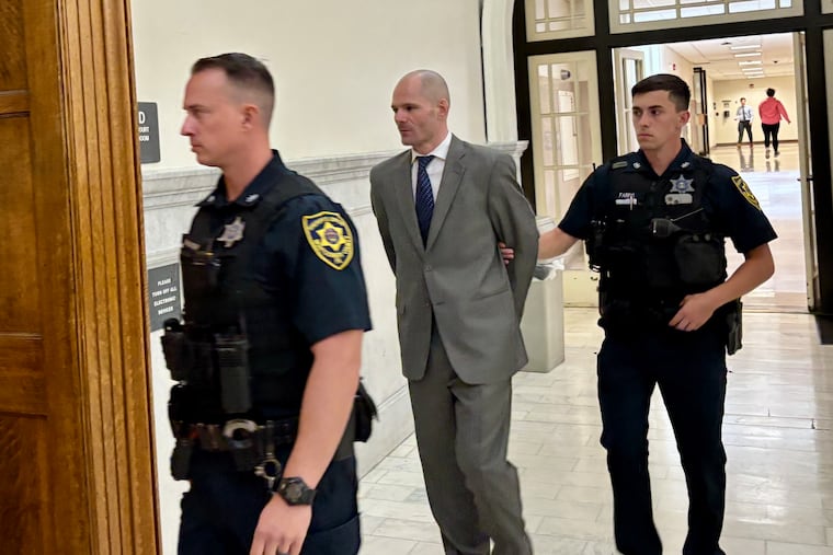 Nathan Blose is escorted into a courtroom at the Montgomery County courthouse during his trial on strangulation and simple assault charges.
