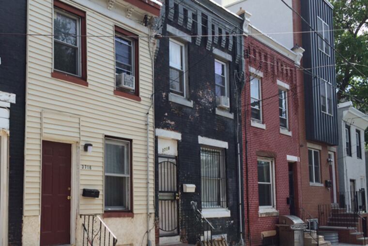 The black-painted house, center, was the scene of a burglary that allegedly involved the son of Kermit Gosnell.