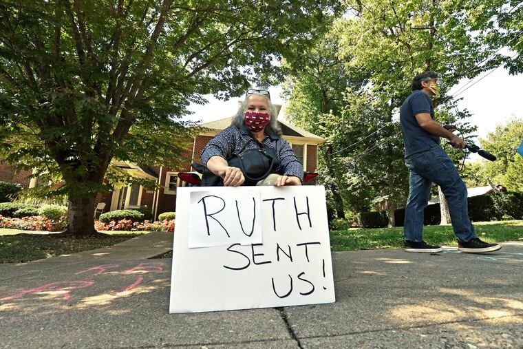 A protester sits outside the house of Senate Majority Leader Mitch McConnell (R., Ky.) in Louisville, Ky., Saturday, Sept. 19, 2020. McConnell vowed on Friday night, hours after the death of Supreme Court Justice Ruth Bader Ginsburg, to call a vote for whomever President Donald Trump nominated as her replacement. (AP Photo/Timothy D. Easley)