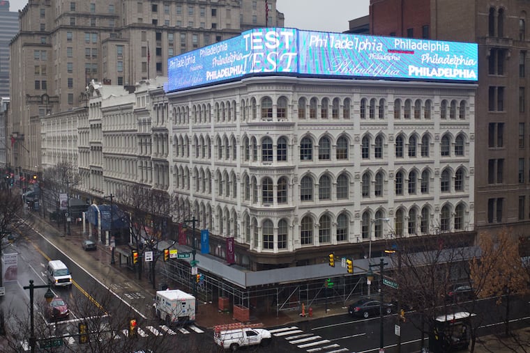 The large digital sign that plays videos at Eighth and Market Streets is said to be an issue for residents and drivers.