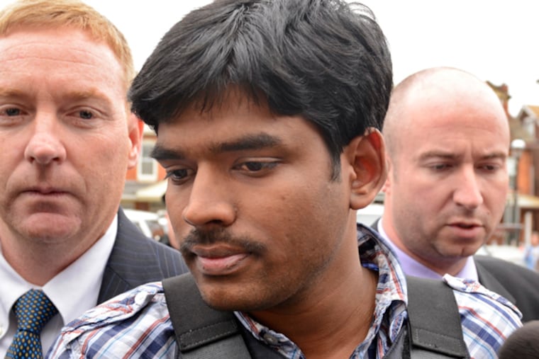 In body armor, Raghunanean Yandamuri is taken into District Court in Bridgeport October 26, 2012. (Tom Gralish / Staff Photographer)