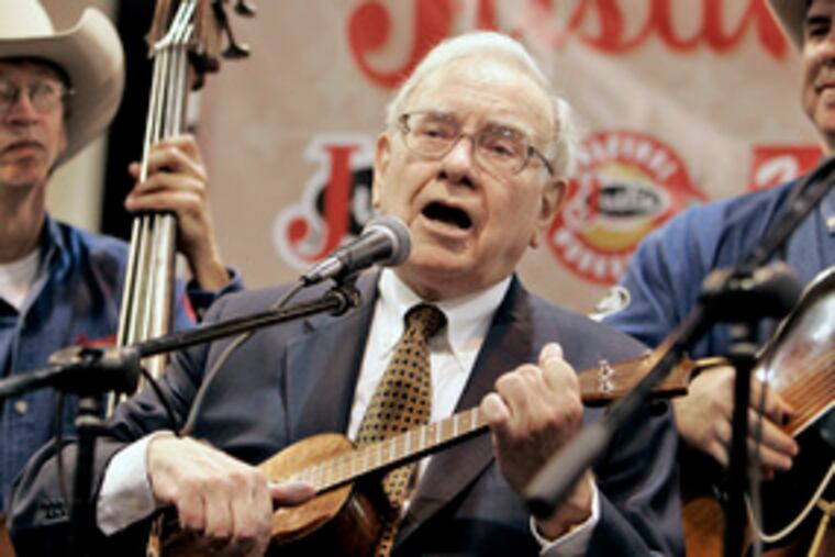 Chairman Warren Buffett played ukulele Saturday in Omaha, Neb., at the Berkshire Hathaway annual meeting. He told shareholders he'd like to "sell something that I like to buy something huge I like even better."