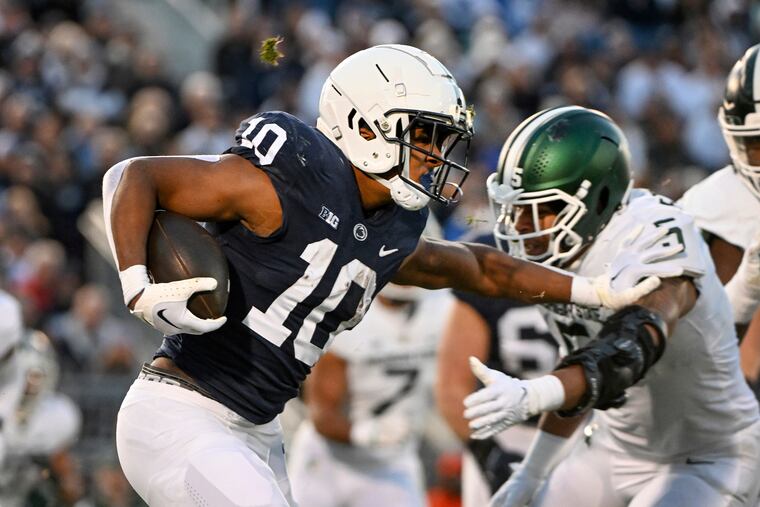Penn State running back Nicholas Singleton stiff-arms Michigan State safety Xavier Henderson during their game on Nov. 26, 2022.