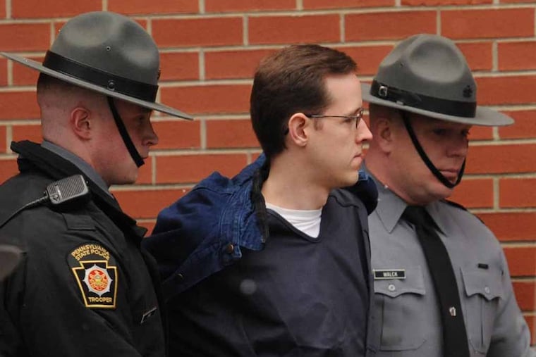 Eric Frein, center, is escorted into the Pike County Courthouse by Pennsylvania state troopers for a preliminary hearing on murder and terrorism charges Monday, Jan. 5, 2015 in Milford, Pa.