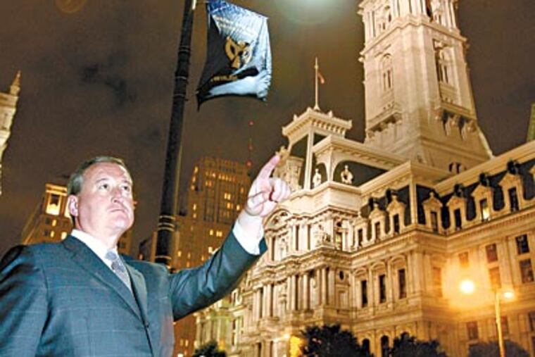 City Councilman James Kenney is among those in favor of replacing the yellowish streetlights with LEDs, such as this one near City Hall. (CHARLES FOX / Staff Photographer)