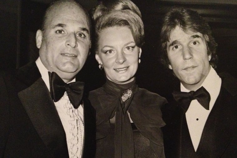 Mr. Milgram (left) and his wife, Carol, pose with actor Henry Winkler at a Variety Club function.