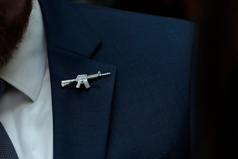 A congressional staffer wears a rifle shaped pin on his suit during a House Judiciary Committee mark up hearing in the Rayburn House Office Building on June 2, 2022 in Washington, D.C.