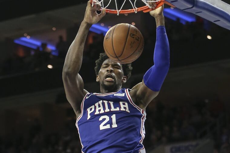 Sixers' Joel Embiid slam dunks against the Pacers during the 4th quarter at the Wells Fargo Center in Philadelphia, Tuesday, March 13, 2018.