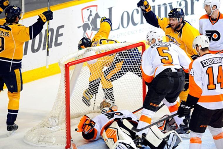 Philadelphia Flyers goalie Ray Emery (29) attempts to make a save against Nashville Predators center Mike Fisher (12) during the second period at Bridgestone Arena. (Christopher Hanewinckel/USA TODAY Sports)