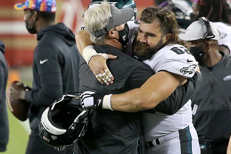 Eagles head coach Doug Pederson (left) and Eagles center Jason Kelce embraced after the Eagles won Sunday night.