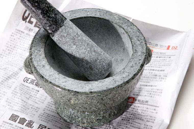 Large stone mortar and pestle ($29.99), at 1st Oriental Market. MICHAEL BRYANT / Staff Photographer