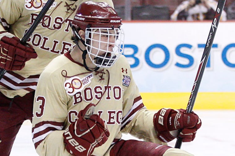 Boston College's Johnny Gaudreau, right, celebrates his goal with teammate Bill Arnold, left, during the first period of an NCAA men's college hockey Frozen Four tournament game against Union, Thursday, April 10, 2014, in Philadelphia. (Chris Szagola/AP)