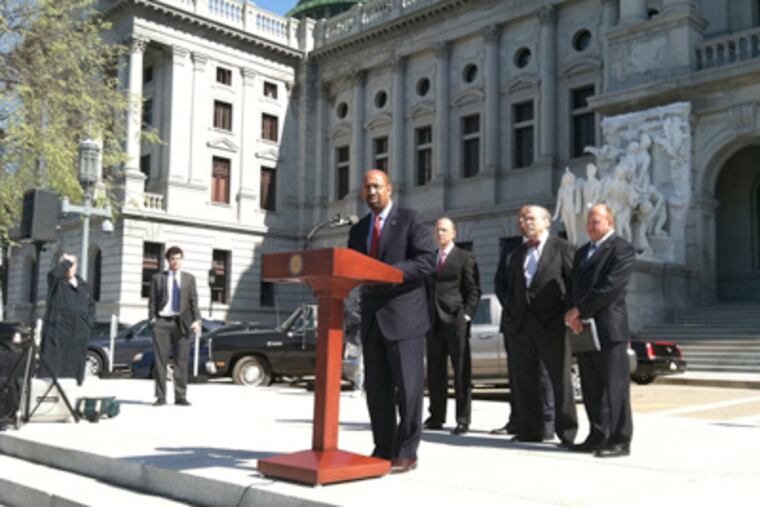 Mayor Nutter speaking in Harrisburg, where he joined mayors against bills that could end local gun laws. (Amy Worden / Staff)