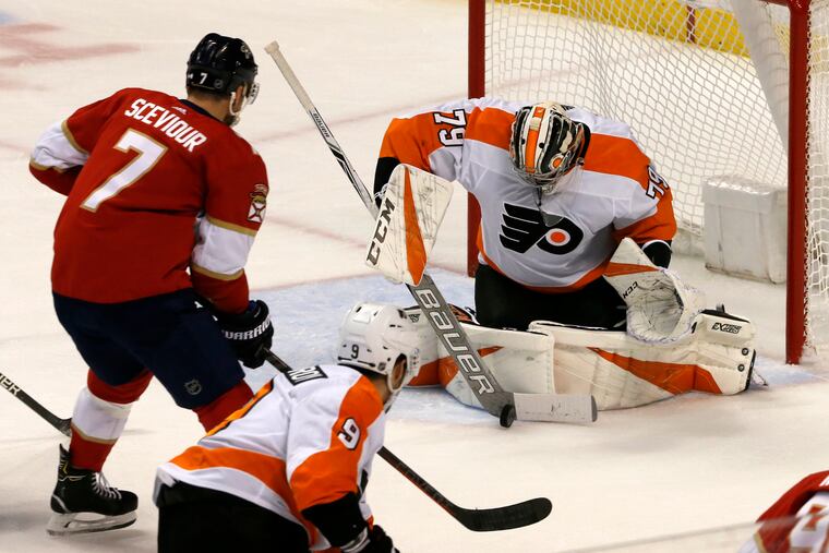 Flyers rookie goaltender Carter Hart makes a save on Florida Panthers center Colton Sceviour (7) on Saturday.