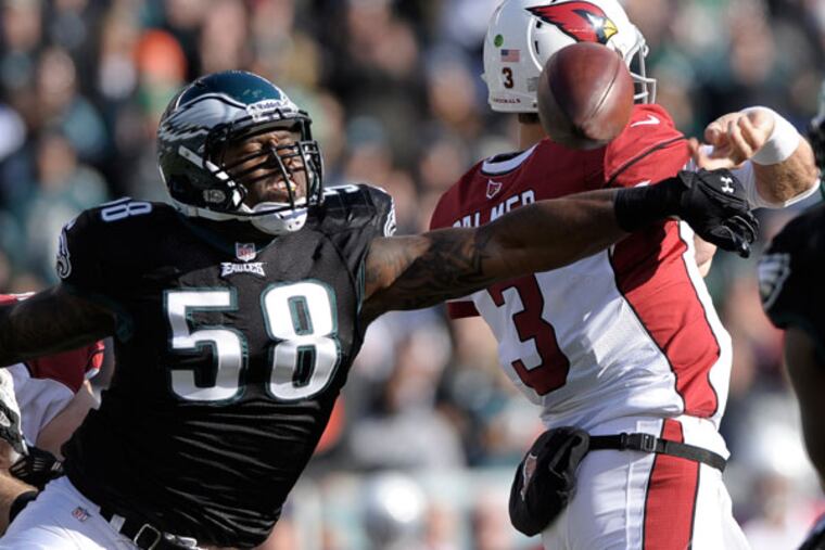Trent Cole (58) knocks the ball loose from Arizona Cardinals' Carson Palmer during the first half of an NFL football game, Sunday, Dec. 1, 2013, in Philadelphia. (Michael Perez/AP)