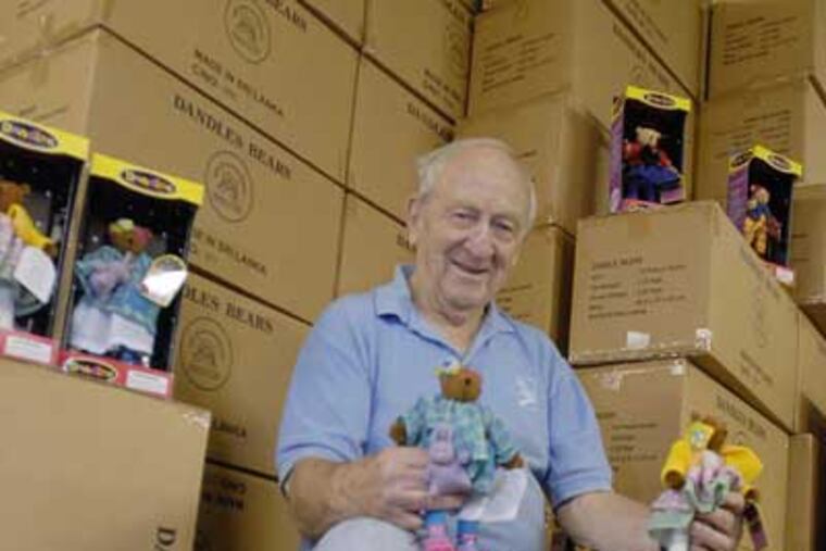 Hal Taussig sits with boxes full of toy bears he will give away to help the Free Library or some other institution raise money. (Ron Tarver / Staff Photographer)
