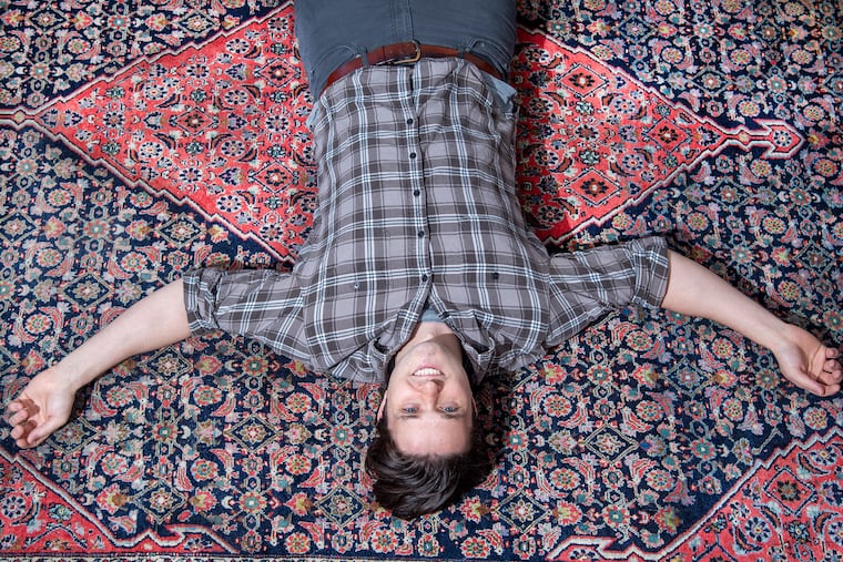 Matt Packard is photographed with his Persian rug at his home in Philadelphia. Packard tells the story of his family's 100-year-old Persian rug, which was delivered to his house but stolen off the front stoop ... and then (long story) mysteriously returned.