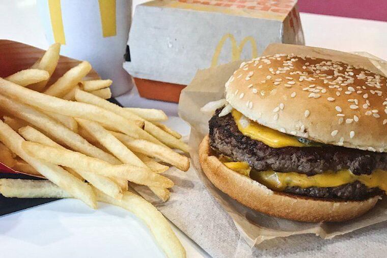 A McDonald's cheeseburger and an order of french fries in 2018.