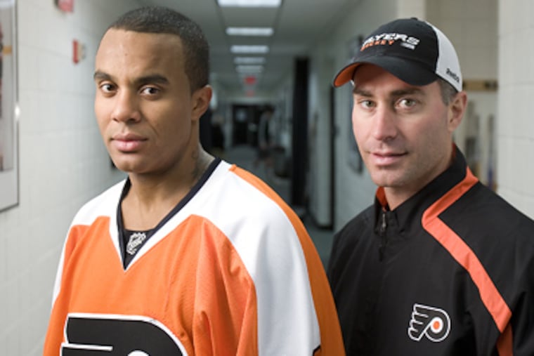 Goalie Ray Emery has forged a bond with coach John Stevens and teammates. ( David Maialetti / Staff Photographer )