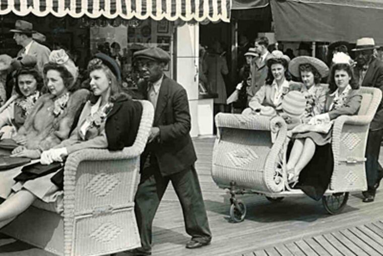 Waiting on those who frolicked: African American men pushing rolling chairs along the Atlantic City Boardwalk in 1942.
