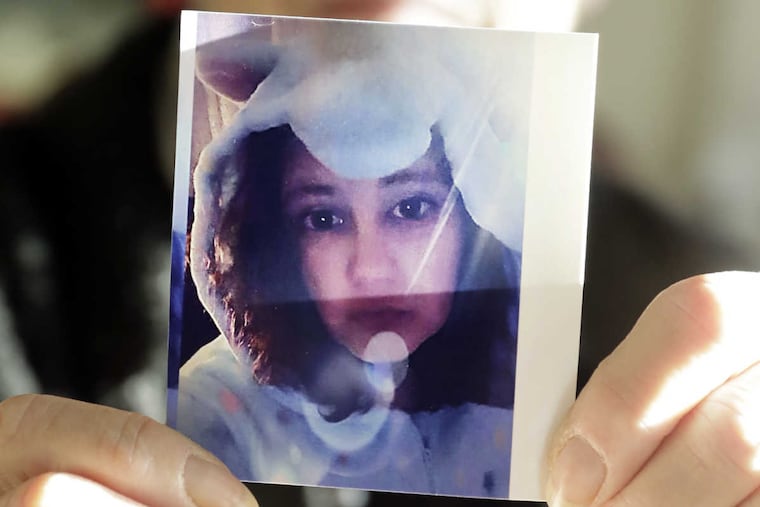 Debbie Fuller holds her favorite photo of daughter Sarah Fuller, who's dressed in a costume for Halloween, in 2014 or 2015.