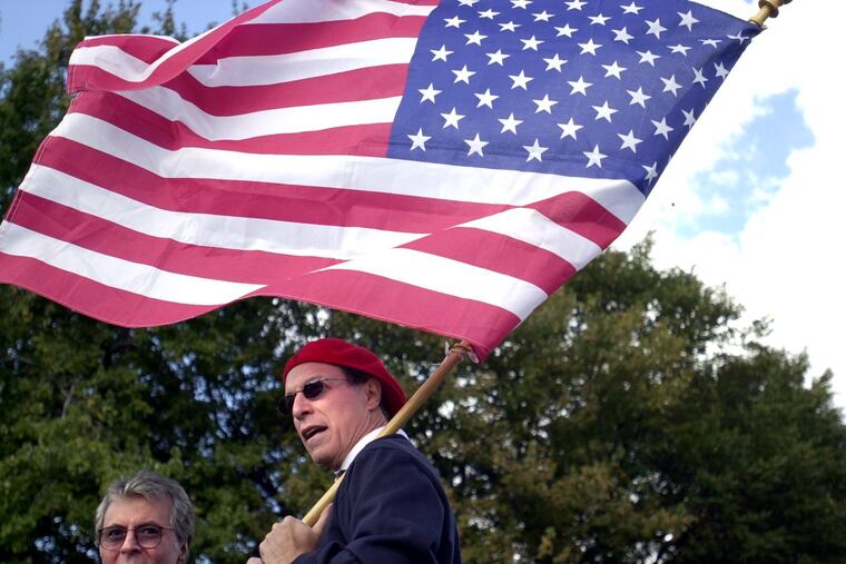 Jerry Blavat waves an American flag during the 2001 Columbus Day Parade in Philadelphia.