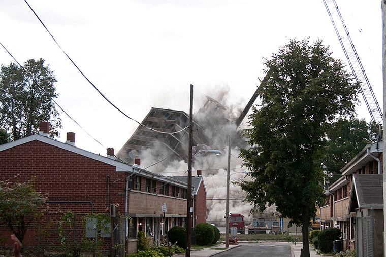 What is left of the building falls in upon itself.