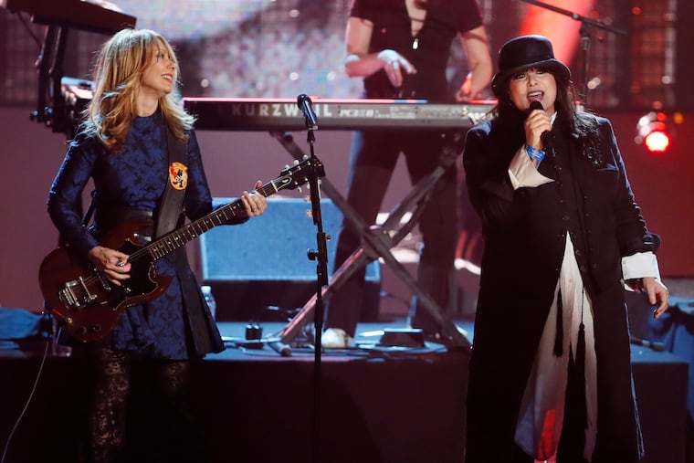 Nancy Wilson, left, and Ann Wilson, of the band Heart, perform as the band is inducted into the Rock and Roll Hall of Fame during the Rock and Roll Hall of Fame Induction Ceremony in Los Angeles on April 18, 2013. (Photo by Danny Moloshok/Invision/AP, File)