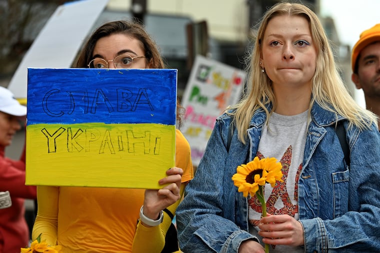 Jennifer Ferd and Margarita Lyadova (right) attend a Support Ukraine on the Parkway rally under the Ukrainian Flag on the Benjamin Franklin Parkway at 17th St.